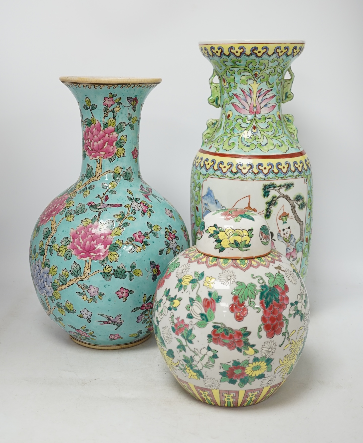 Two 20th century Chinese famille rose vases and a similar jar and cover, tallest 40cm. Condition - good